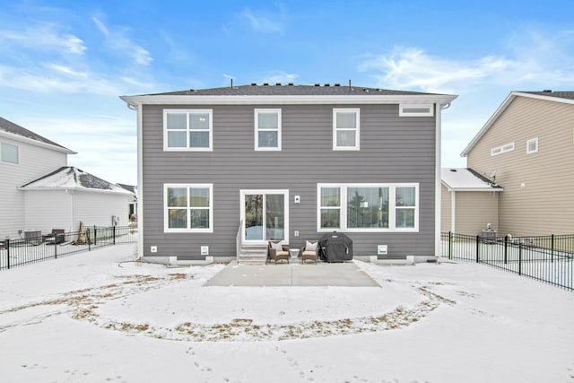 view of snow covered rear of property