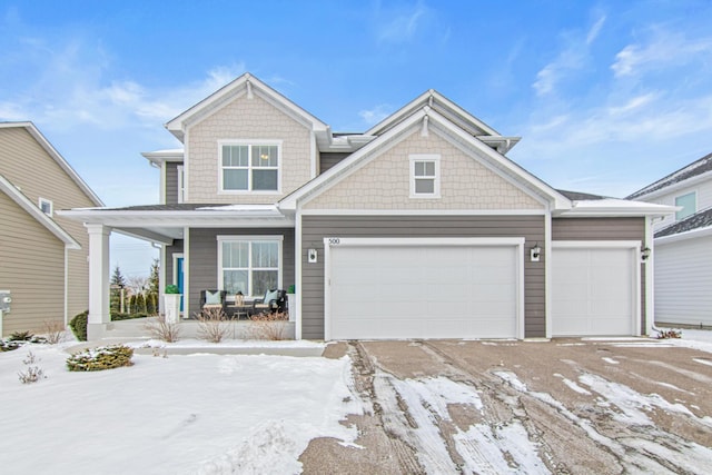 view of front facade featuring a garage and covered porch