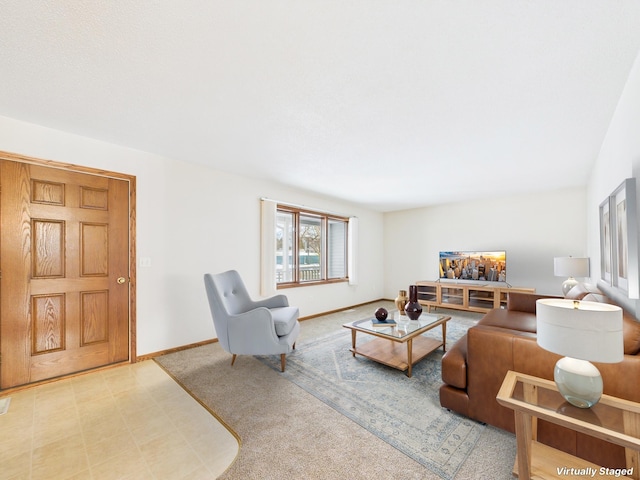 living area featuring baseboards