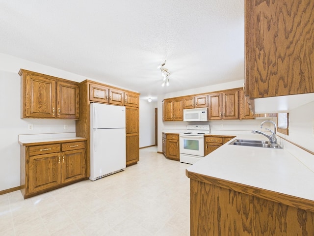 kitchen with white appliances, brown cabinetry, light floors, a sink, and light countertops