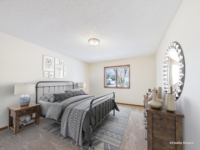 carpeted bedroom with baseboards and a textured ceiling