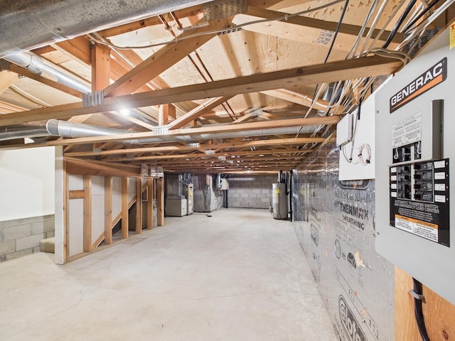 unfinished below grade area featuring water heater and concrete block wall