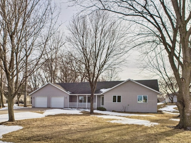 ranch-style home with a porch, a yard, a garage, and driveway