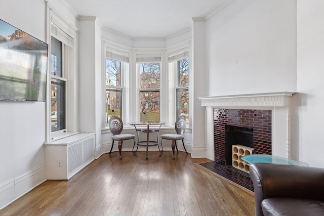 598 Summit Ave Unit 1, Saint Paul, MN 55102 - living area with ornamental molding, wood-type flooring, and a fireplace with flush hearth