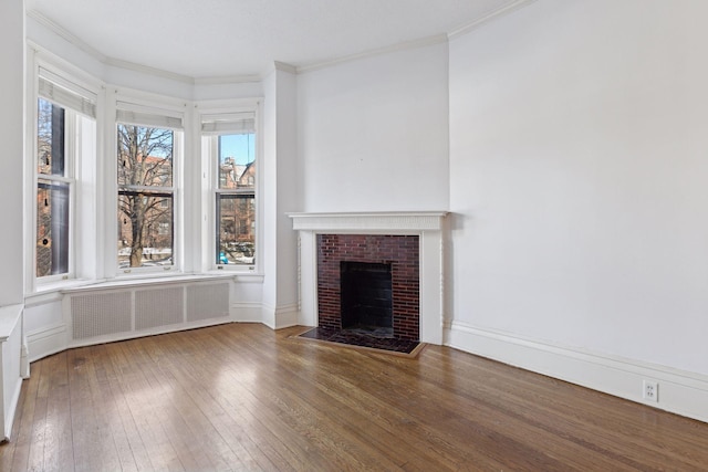 598 Summit Ave Unit 1, Saint Paul, MN 55102 - unfurnished living room with radiator, hardwood / wood-style flooring, a fireplace with flush hearth, and crown molding