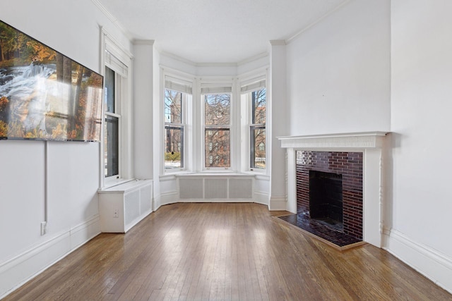 598 Summit Ave Unit 1, Saint Paul, MN 55102 - unfurnished living room with hardwood / wood-style flooring, ornamental molding, radiator heating unit, and a tile fireplace