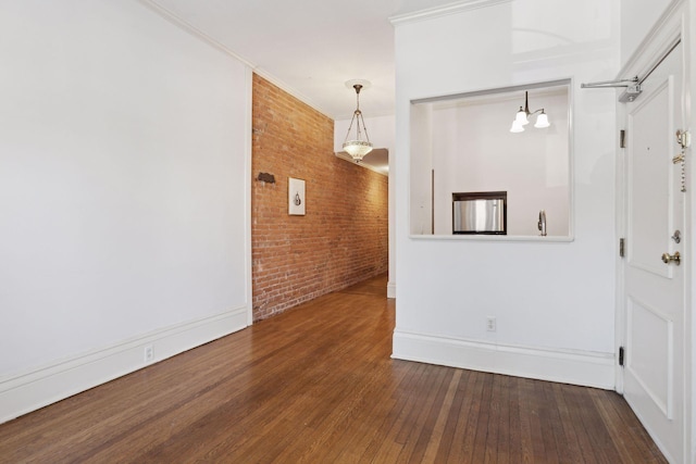 598 Summit Ave Unit 1, Saint Paul, MN 55102 - entrance foyer with brick wall, wood-type flooring, crown molding, and baseboards