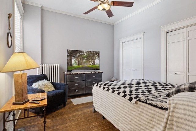 598 Summit Ave Unit 1, Saint Paul, MN 55102 - bedroom with radiator, ornamental molding, dark wood-type flooring, two closets, and a ceiling fan