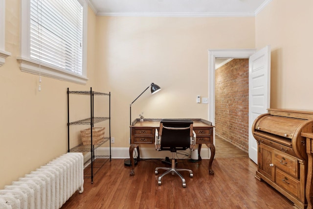 598 Summit Ave Unit 1, Saint Paul, MN 55102 - office with radiator, wood finished floors, crown molding, brick wall, and baseboards