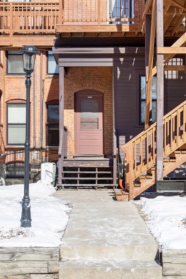 598 Summit Ave Unit 1, Saint Paul, MN 55102 - snow covered property entrance featuring brick siding and a balcony