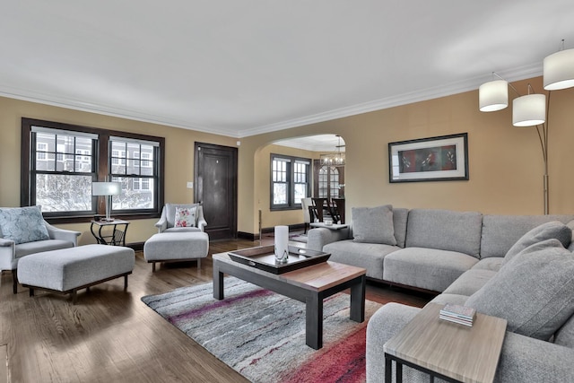 living room with ornamental molding, dark hardwood / wood-style floors, and a notable chandelier