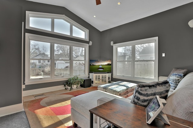 living room with ceiling fan, tile patterned flooring, and vaulted ceiling