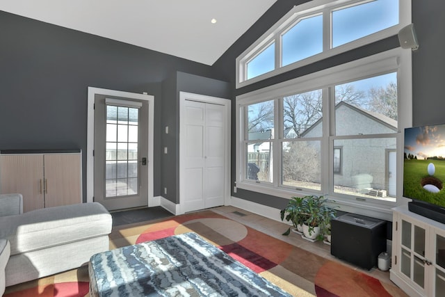 living room featuring high vaulted ceiling