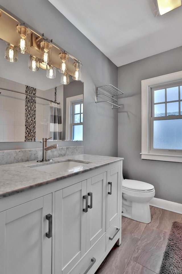 bathroom with vanity, curtained shower, and toilet