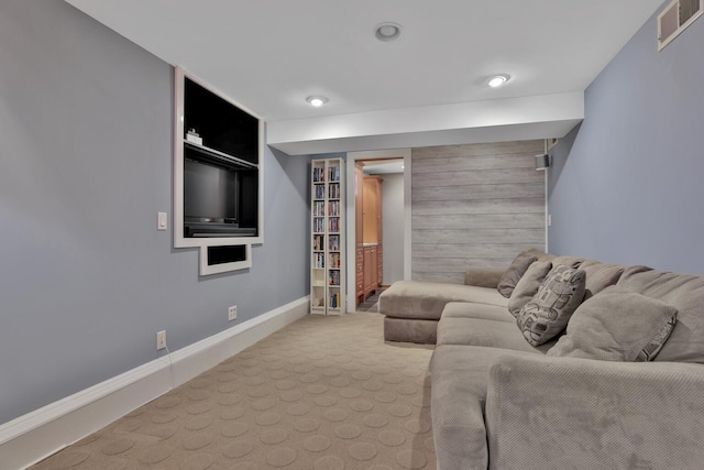 carpeted living room with wooden walls and built in features