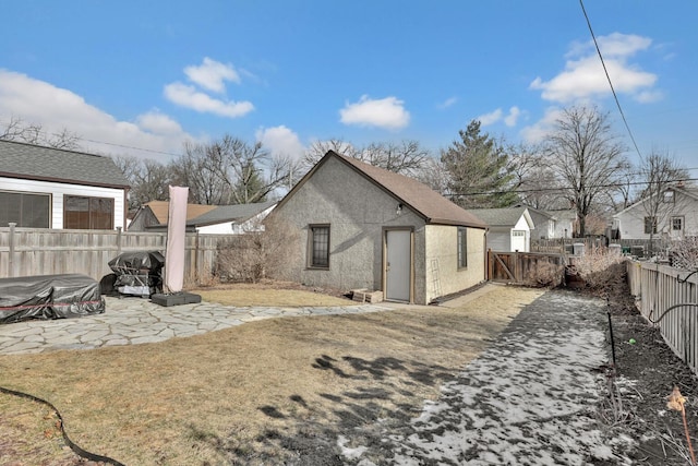 back of property featuring a lawn and a patio area