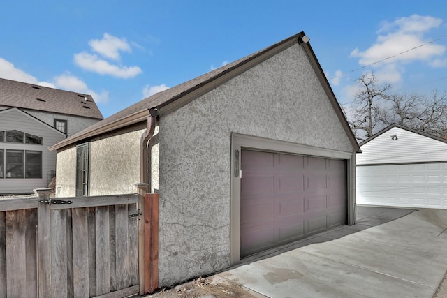 view of home's exterior with a garage and an outdoor structure