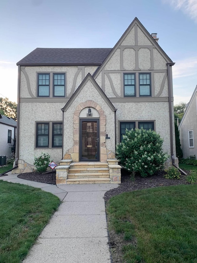 tudor house with a front lawn