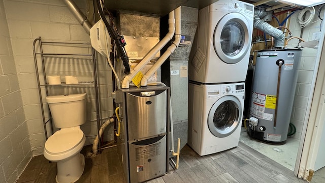 laundry room with stacked washer / dryer, wood-type flooring, and gas water heater