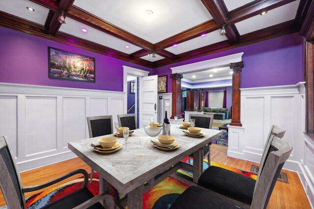 dining room with beamed ceiling, coffered ceiling, and decorative columns