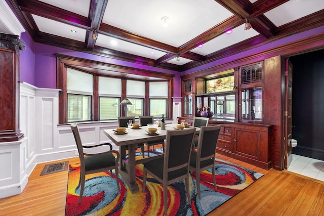 dining area featuring coffered ceiling, visible vents, a decorative wall, and beamed ceiling