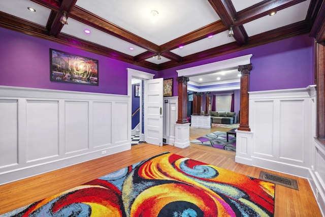 bedroom with ornate columns, visible vents, coffered ceiling, and beam ceiling