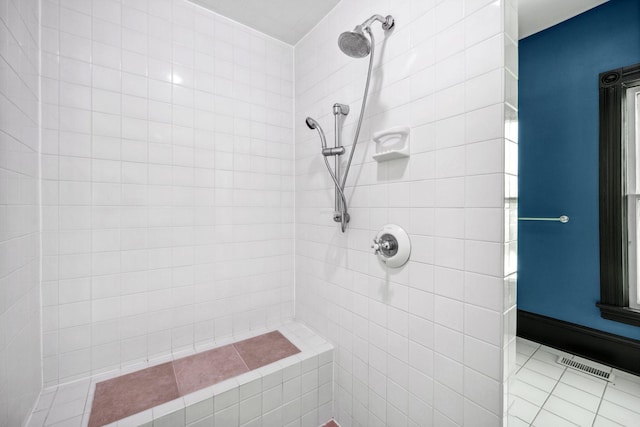 bathroom with visible vents and tiled shower