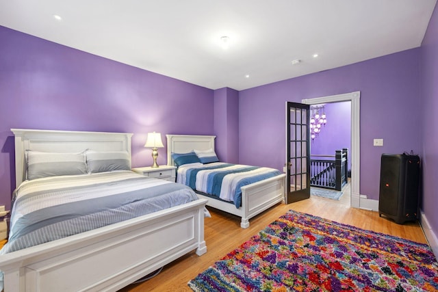 bedroom featuring light wood-style floors, recessed lighting, and baseboards