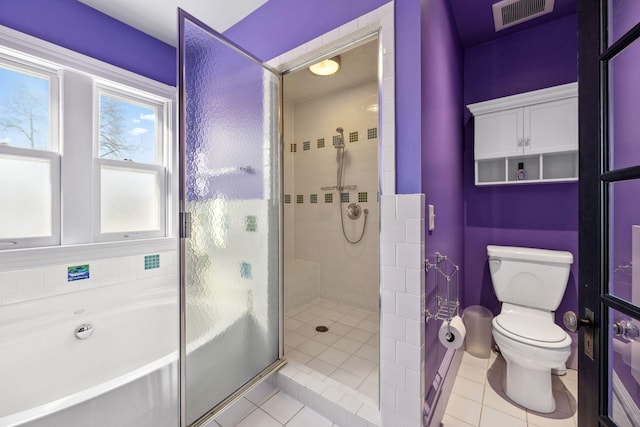 full bathroom featuring tile patterned flooring, toilet, visible vents, a shower stall, and a bath