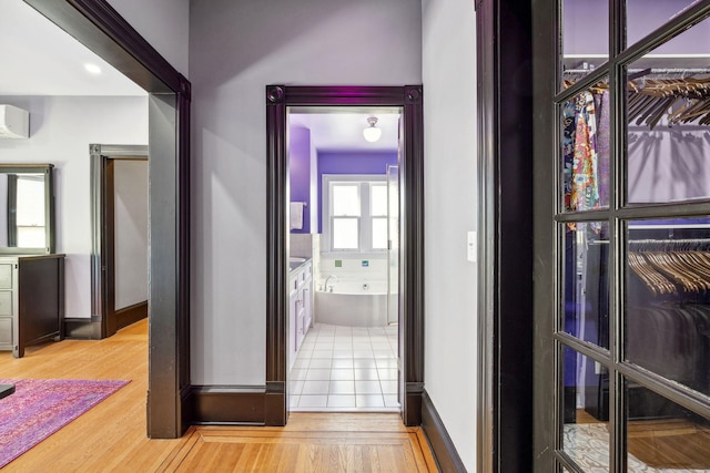 corridor with wood finished floors and baseboards