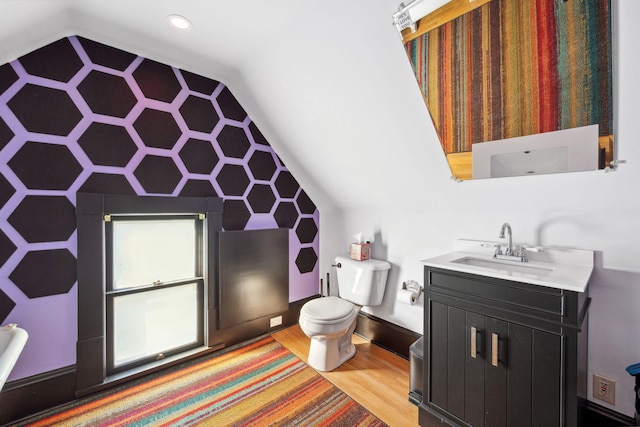 full bathroom with lofted ceiling, vanity, wood finished floors, and toilet