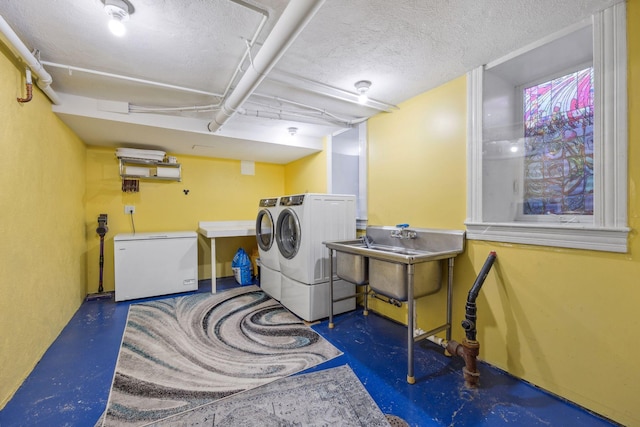 laundry area with laundry area, a textured ceiling, and separate washer and dryer