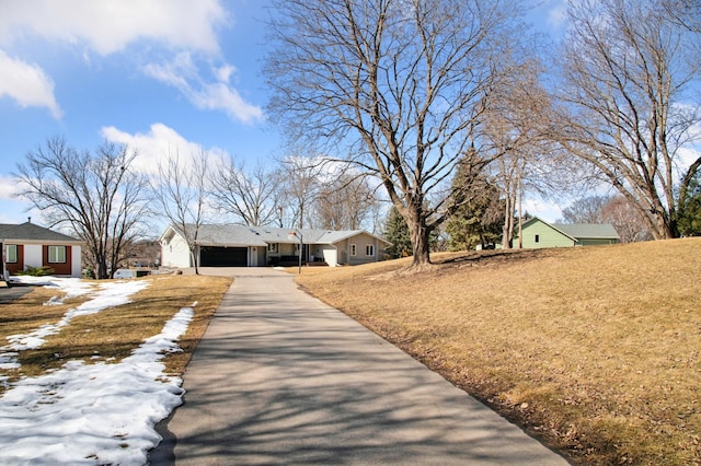 view of front facade with aphalt driveway and an attached garage