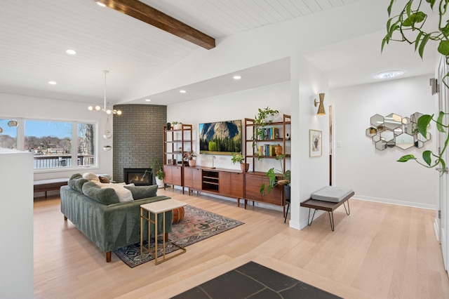 living area with vaulted ceiling with beams, a fireplace, recessed lighting, light wood-style floors, and a chandelier