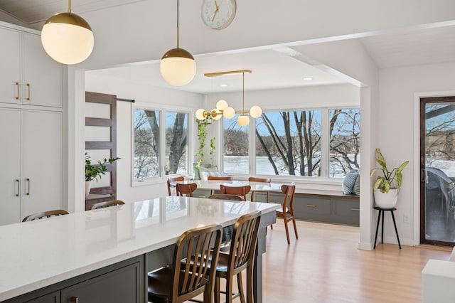 dining area with a chandelier and light wood finished floors