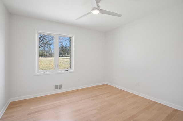 empty room featuring visible vents, baseboards, light wood-style flooring, and a ceiling fan