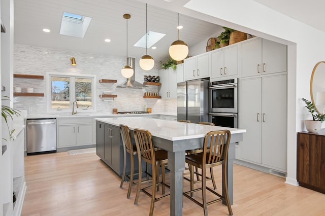 kitchen with range hood, open shelves, a sink, stainless steel appliances, and light countertops