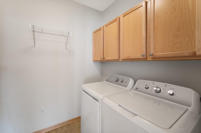 laundry area featuring cabinet space, tile patterned flooring, baseboards, and independent washer and dryer