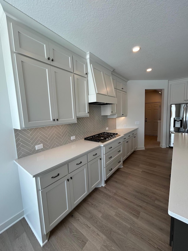 kitchen with appliances with stainless steel finishes, light countertops, and white cabinetry