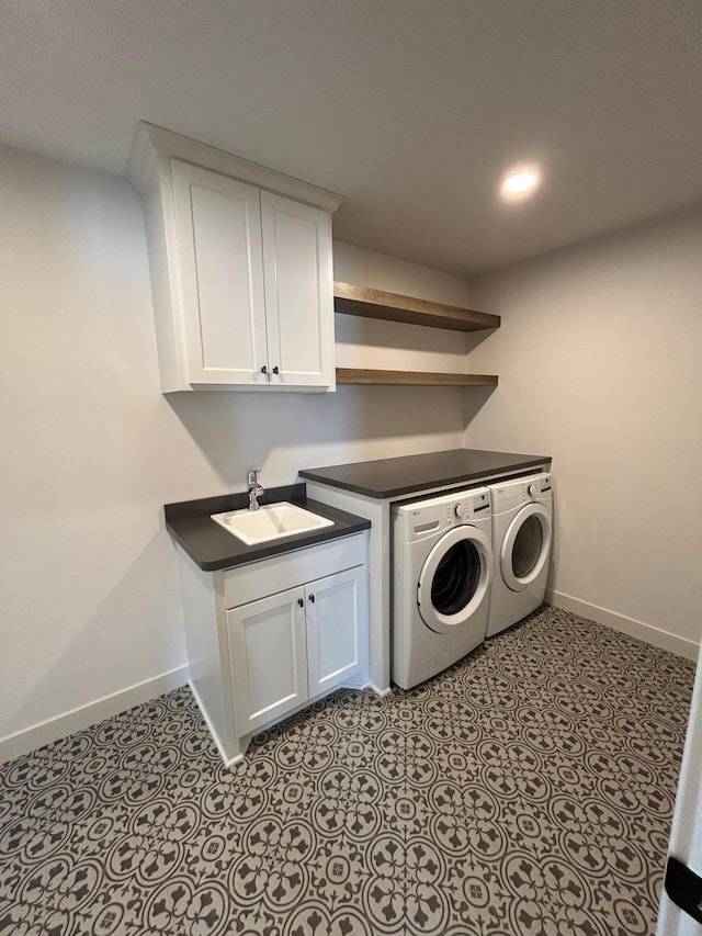 laundry room featuring light tile patterned floors, a sink, baseboards, and separate washer and dryer