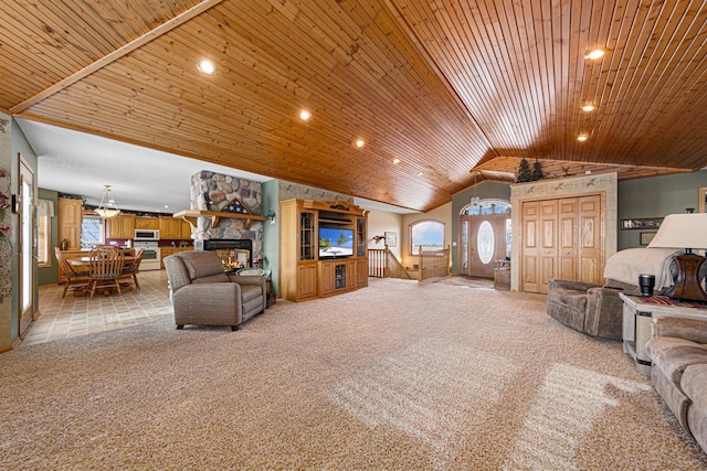 carpeted living room with vaulted ceiling, a fireplace, and wood ceiling