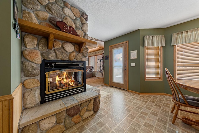 living room featuring a fireplace and a textured ceiling