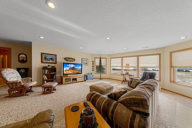 living room with a healthy amount of sunlight, carpet, and a textured ceiling