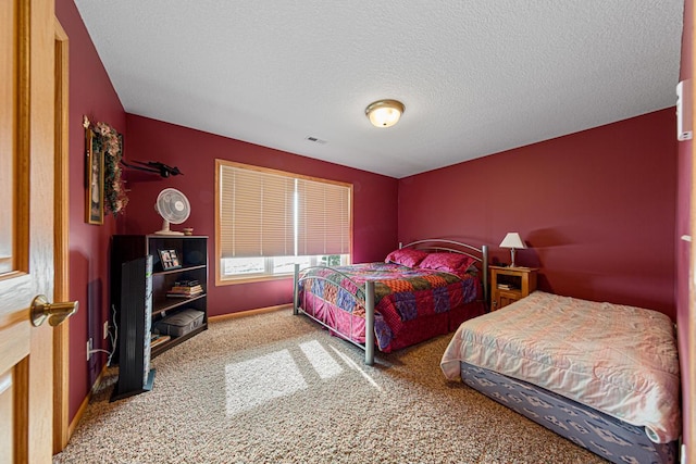 carpeted bedroom featuring a textured ceiling