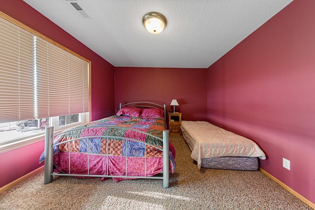 carpeted bedroom with a textured ceiling