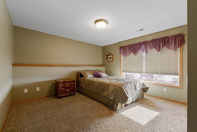 carpeted bedroom with a textured ceiling