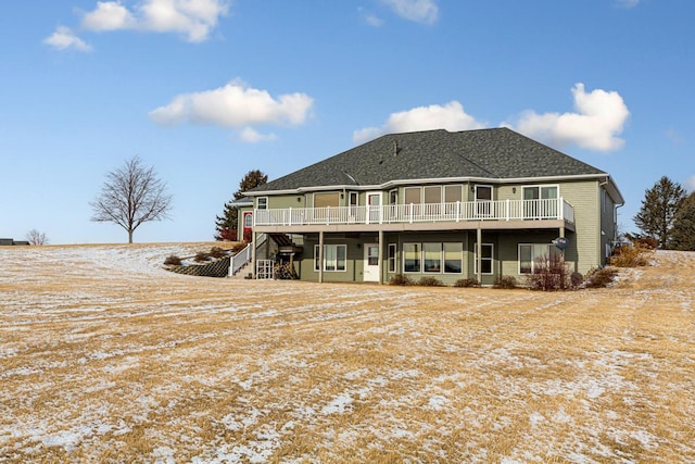 snow covered house featuring a wooden deck