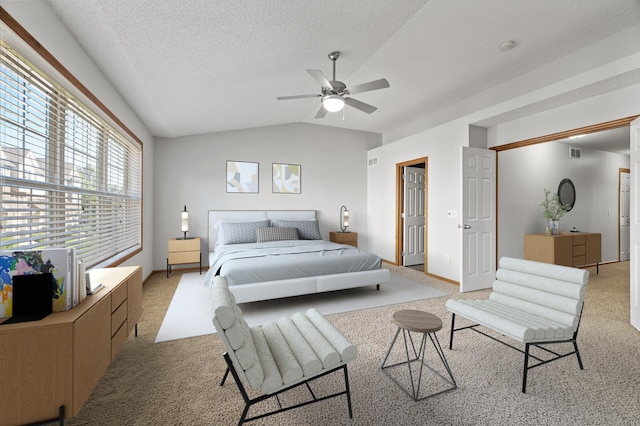 bedroom with a textured ceiling, light colored carpet, a ceiling fan, visible vents, and vaulted ceiling