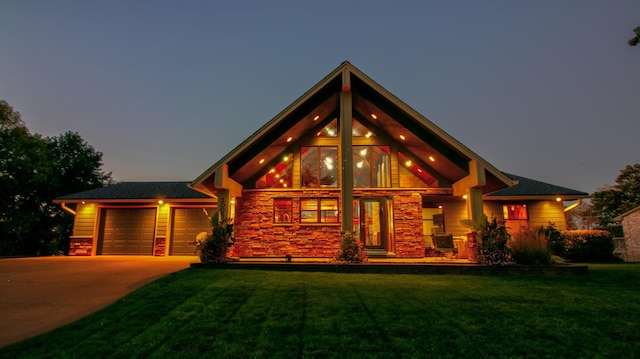 view of front of property featuring a garage, stone siding, a front lawn, and concrete driveway