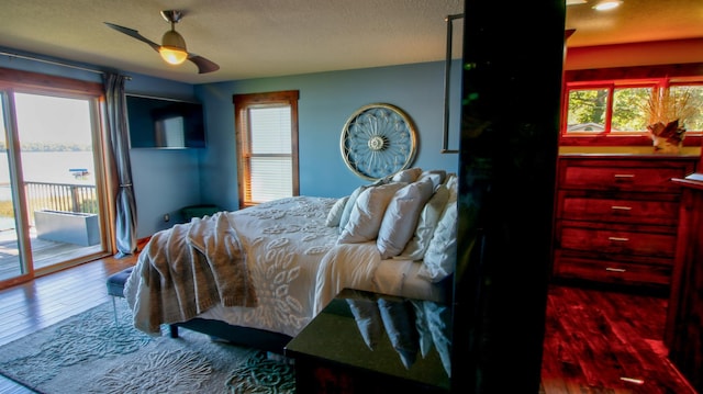 bedroom featuring a textured ceiling, access to outside, wood finished floors, and a ceiling fan